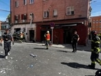 Firefighters work at the site after an explosion in a cafe injured at least 21 people, three of them seriously in Madrid. 