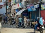 Security personnel check a commuter's two-wheeler after security was beefed up in view of the protests against the detention of AAP MLA Mehraj Malik under the Public Safety Act, in Doda district, Jammu and Kashmir, Saturday. (PTI)