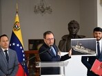 Venezuela's Foreign Minister Yvan Gil shows a picture of a boat bearing a US flag during a press conference at the Ministry of Foreign Affairs in Caracas on September 13, 2025. Venezuela on Saturday hit out at the United States for allegedly seizing a fishing boat for eight hours in its exclusive economic zone.