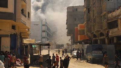 Smoke billows from an evacuated UNRWA school following Israeli airstrikes, at al-Shati (Beach) refugee camp, in Gaza. (REUTERS)