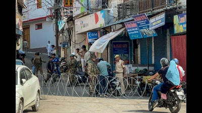 Security personnel check a commuter's two-wheeler after security was beefed up in view of the protests against the detention of AAP MLA Mehraj Malik under the Public Safety Act, in Doda district, Jammu and Kashmir, Saturday. (PTI) Security personnel check a commuter's two-wheeler after security was beefed up in view of the protests against the detention of AAP MLA Mehraj Malik under the Public Safety Act, in Doda district, Jammu and Kashmir, Saturday. (PTI)