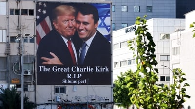 A billboard showing an image of US President Donald Trump (L) embracing US prominent right-wing activist Charlie Kirk, who was hit by a single bullet while addressing a large crowd at Utah Valley University in the town of Orem on September 10, hangs on the side of a building in Tel Aviv, on September 13, 2025. (AFP) A billboard showing an image of US President Donald Trump (L) embracing US prominent right-wing activist Charlie Kirk, who was hit by a single bullet while addressing a large crowd at Utah Valley University in the town of Orem on September 10, hangs on the side of a building in Tel Aviv, on September 13, 2025. (AFP)
