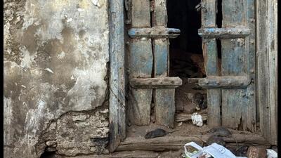 The road is climaxed by a beautiful but severely damaged door, fronted by a pile of garbage. (HT Photo)