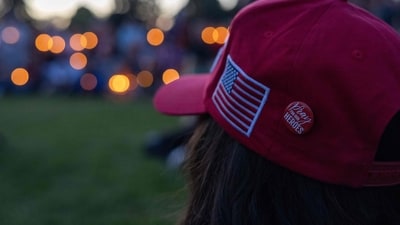 A person wears a pin reading "pray for our heroes" during a candlelight vigil for right-wing activist Charlie Kirk at a makeshift memorial at Memorial Park in Provo, Utah, on September 12, 2025, after he was shot during a public event at Utah Valley University. (Photo by Melissa MAJCHRZAK / AFP) (AFP) A person wears a pin reading "pray for our heroes" during a candlelight vigil for right-wing activist Charlie Kirk at a makeshift memorial at Memorial Park in Provo, Utah, on September 12, 2025, after he was shot during a public event at Utah Valley University. (Photo by Melissa MAJCHRZAK / AFP) (AFP)