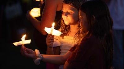 A young girl holds a candle during a candlelight vigil for right-wing activist Charlie Kirk at a makeshift memorial at Memorial Park in Provo, Utah, on September 12, 2025, after he was shot during a public event at Utah Valley University. (Photo by Melissa MAJCHRZAK / AFP) (AFP) A young girl holds a candle during a candlelight vigil for right-wing activist Charlie Kirk at a makeshift memorial at Memorial Park in Provo, Utah, on September 12, 2025, after he was shot during a public event at Utah Valley University. (Photo by Melissa MAJCHRZAK / AFP) (AFP)