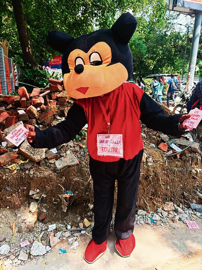 At North Campus, a person dressed as Mickey Mouse grabs attention while handing out flyers. At North Campus, a person dressed as Mickey Mouse grabs attention while handing out flyers.