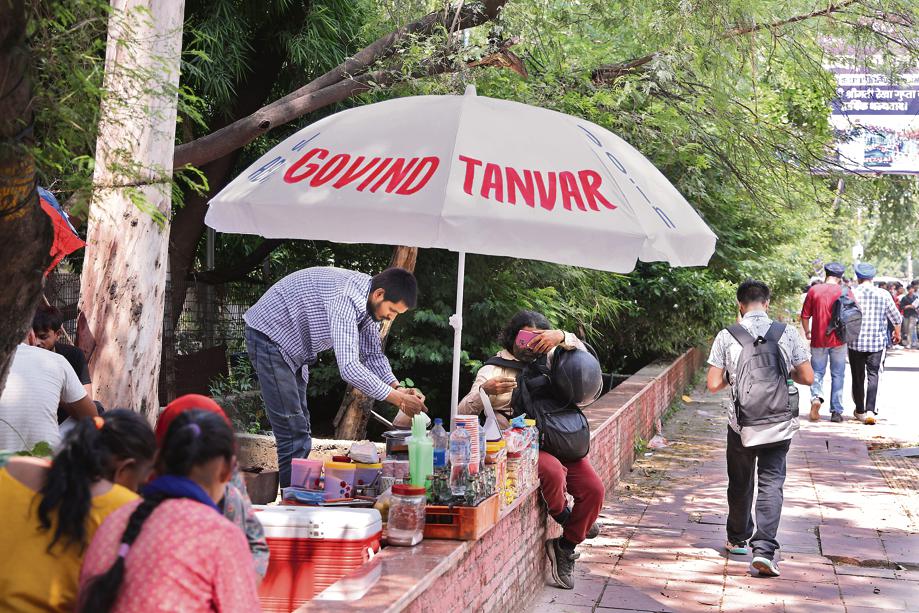 tea stall near the Faculty of Law now sits under a giant umbrella emblazoned with a candidate’s name. tea stall near the Faculty of Law now sits under a giant umbrella emblazoned with a candidate’s name.