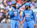 India's Virat Kohli (L) speaks with Rohit Sharma. India's Virat Kohli (L) speaks with Rohit Sharma.