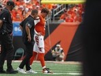 Joe Burrow #9 of the Cincinnati Bengals is helped off the field following an injury in the second quarter 