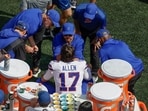 Trainers and coaches tend to Buffalo Bills quarterback Josh Allen's (17) bloody nose Trainers and coaches tend to Buffalo Bills quarterback Josh Allen's (17) bloody nose