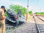 Police at the spot where the car fell, on a railway track below Mukarba Chowk flyover. (ANI) Police at the spot where the car fell, on a railway track below Mukarba Chowk flyover. (ANI)