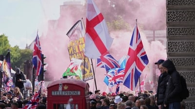 People demonstrate during the Tommy Robinson-led Unite the Kingdom march and rally, in London. (AP) People demonstrate during the Tommy Robinson-led Unite the Kingdom march and rally, in London. (AP)