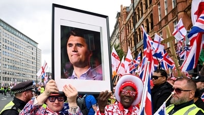 Protesters hold a picture of U.S. conservative activist Charlie Kirk, who was fatally shot while speaking at an event at Utah Valley University, on the day of an anti-immigration rally in London (Reuters)