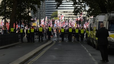 London Police officers stand guard as protesters attend an anti-immigration rally organised by British anti-immigration activist Stephen Yaxley-Lennon. (Reuters)