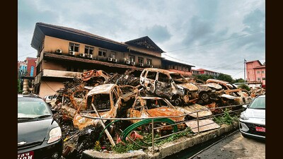 Charred vehicles dumped outside the damaged building of Nepal Supreme Court. (HT Photo)