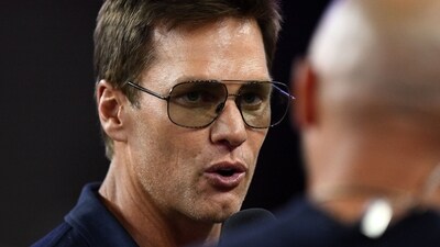 Aug 8, 2025; Foxborough, Massachusetts, USA; Retired Hall of Fame New England Patriot player Tom Brady talks with Brian Hoyer during the first half of a game against the Washington Commanders at Gillette Stadium. Mandatory Credit: Brian Fluharty-Imagn Images (IMAGN IMAGES via Reuters Connect)