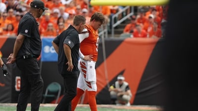 Joe Burrow #9 of the Cincinnati Bengals is helped off the field following an injury in the second quarter (Getty Images via AFP) Joe Burrow #9 of the Cincinnati Bengals is helped off the field following an injury in the second quarter (Getty Images via AFP)