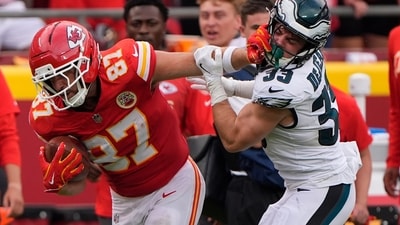 Kansas City Chiefs tight end Travis Kelce (87) runs for a first down as Philadelphia Eagles defensive back Cooper DeJean (33) defends (AP)