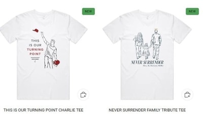 One top has a line-art drawing of Charlie Kirk, his wife, and their two kids strolling hand in hand into the distance while sporting a gold halo over his head. One top has a line-art drawing of Charlie Kirk, his wife, and their two kids strolling hand in hand into the distance while sporting a gold halo over his head.
