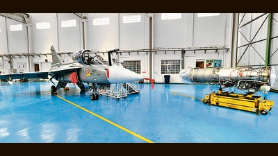 An LCA Mk-1A and a GE F404-IN20 engine at an HAL facility in Bengaluru. (Rahul Singh/HT Photo)