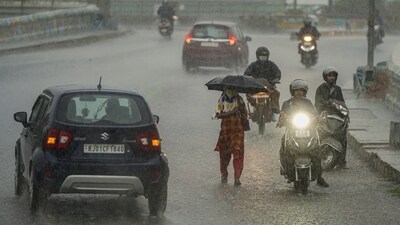 Commuters wade through a waterlogged street following heavy rains in Ajmer, Rajasthan, on September 4. (PTI) Commuters wade through a waterlogged street following heavy rains in Ajmer, Rajasthan, on September 4. (PTI)