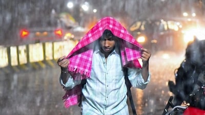 A man commutes through amid heavy rain, in Hyderabad on Sunday. (ANI/Representational) A man commutes through amid heavy rain, in Hyderabad on Sunday. (ANI/Representational)