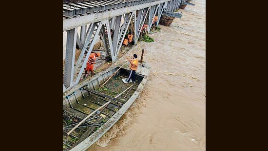 NDRF personnel clearing the hyacinth below the Gidderpindi railway bridge when the flow of Sutlej was at its peak in early September. (HT File)