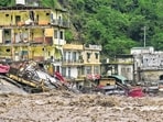 Damaged houses alongside a river following heavy rain in Sahastradhara near Dehradun on Tuesday. (PTI)