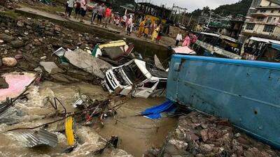 Buses and vehicles swept away during the flashflood following heavy overnight rain at Dharampur in Mandi district on Tuesday. (HT Photo)