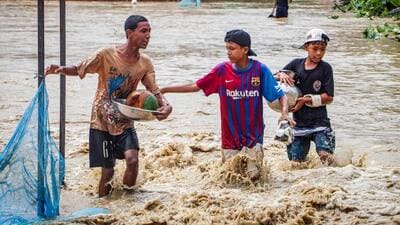 Children wade through a flooded street after heavy monsoon rain showers in Imphal East, in Manipur on Monday. (AFP) Children wade through a flooded street after heavy monsoon rain showers in Imphal East, in Manipur on Monday. (AFP)