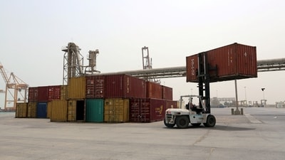 A forklift carries a shipping container at the Red Sea port of Hodeidah, Yemen. (Reuters)