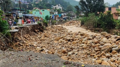 Sections of road in Uttarakhand's Dehradun were washed away after heavy rainfall triggered a cloudburst in the area on Tuesday. (PTI) Sections of road in Uttarakhand's Dehradun were washed away after heavy rainfall triggered a cloudburst in the area on Tuesday. (PTI)