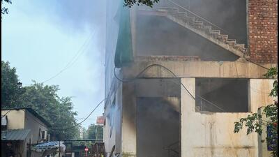 Eight fire engines from surrounding fire stations were rushed to the spot, and fire fighters somehow managed to enter the basement wearing breathing apparatus. (Sunil Ghosh/HT Photo)