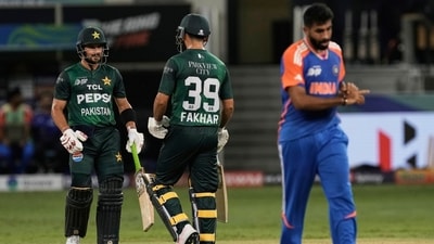 Pakistan's Sahibzada Farhan, left, celebrates scoring runs with batting partner Fakhar Zaman as India's Jasprit Bumrah, right, walks away (AP) Pakistan's Sahibzada Farhan, left, celebrates scoring runs with batting partner Fakhar Zaman as India's Jasprit Bumrah, right, walks away (AP)