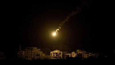 An Israeli army flare drifts over buildings destroyed during the Israeli ground and air operations in the northern Gaza Strip. (AP) An Israeli army flare drifts over buildings destroyed during the Israeli ground and air operations in the northern Gaza Strip. (AP)