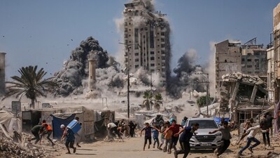 Palestinians run for cover during an Israeli airstrike on a high-rise building in Gaza City, Friday, Sept. 5, 2025, after the Israeli army issued a warning. (AP) Palestinians run for cover during an Israeli airstrike on a high-rise building in Gaza City, Friday, Sept. 5, 2025, after the Israeli army issued a warning. (AP)