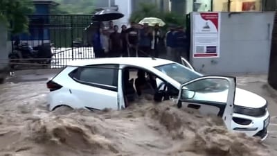 A cloudburst on Tuesday, triggered by heavy rain, led to water flooding the roads and entering vehicles. (PTI) A cloudburst on Tuesday, triggered by heavy rain, led to water flooding the roads and entering vehicles. (PTI)