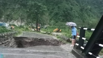 People look at a caved-in portion of a bridge after heavy rain triggered a cloudburst, near Maldevta in Dehradun. (PTI) People look at a caved-in portion of a bridge after heavy rain triggered a cloudburst, near Maldevta in Dehradun. (PTI)