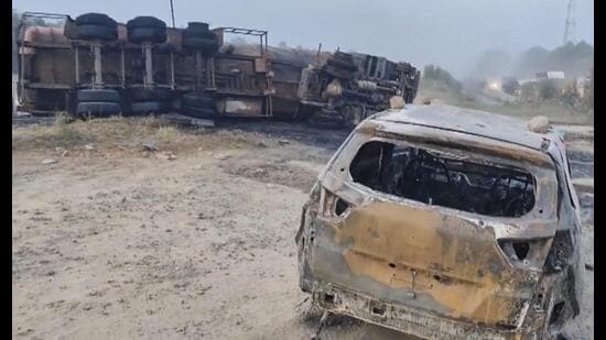 Charred remains of a car that collided with a burning chemical tanker in Rewari on Monday night. (PTI)