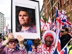 Protesters hold a picture of U.S. conservative activist Charlie Kirk, who was fatally shot while speaking at an event at Utah Valley University, on the day of an anti-immigration rally organised by British anti-immigration activist Stephen Yaxley-Lennon, also known as Tommy Robinson, in London, Britain, September 13, 2025. REUTERS/Jaimi Joy