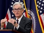 Federal Reserve Chair Jerome Powell gestures during a press conference 