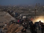 Displaced Palestinians were seen fleeing northern Gaza along the coastal road toward the south, as Israel announced an expanded operation in Gaza City