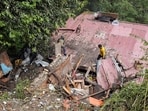 Residents inspect a house, damaged in a landslide following heavy rainfall, in Shimla, Himachal Pradesh, on Tuesday. (PTI) Residents inspect a house, damaged in a landslide following heavy rainfall, in Shimla, Himachal Pradesh, on Tuesday. (PTI)