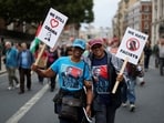 Supporters of former US President Barack Obama hold signs on the day of a 'Trump Not Welcome' protest during the state visit of President Donald Trump, in London on September 17, 2025.