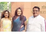 Between Manorama (L), her husband Dilip (R), and their daughter Puja Khedkar. 