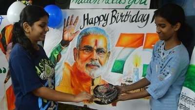 Children celebrate Prime Minister Narendra Modi's birthday with a cake-cutting ceremony at Lalbaug, in Mumbai, India, on Tuesday. (Bhushan Koyande/HT Photo)