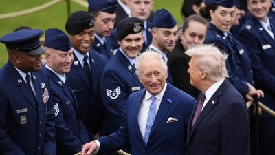 Britain's King Charles III and US President Donald Trump speak to military personnel following a Beating Retreat military ceremony on the East Lawn at Windsor Castle, in Windsor, on September 17, 2025, during the US President's second State Visit. US President Donald Trump arrived in Britain for an unprecedented second State Visit, with the UK government rolling out a royal red carpet welcome to win over the mercurial leader. (Photo by Jordan Pettitt / POOL / AFP) (AFP) Britain's King Charles III and US President Donald Trump speak to military personnel following a Beating Retreat military ceremony on the East Lawn at Windsor Castle, in Windsor, on September 17, 2025, during the US President's second State Visit. US President Donald Trump arrived in Britain for an unprecedented second State Visit, with the UK government rolling out a royal red carpet welcome to win over the mercurial leader. (Photo by Jordan Pettitt / POOL / AFP) (AFP)