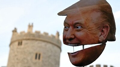 A demonstrator holds a placard of the US President's face during a protest against the forthcoming State Visit of US President Donald Trump, outside Windsor Castle in Windsor on September 16, 2025. (Photo by JUSTIN TALLIS / AFP) (AFP) A demonstrator holds a placard of the US President's face during a protest against the forthcoming State Visit of US President Donald Trump, outside Windsor Castle in Windsor on September 16, 2025. (Photo by JUSTIN TALLIS / AFP) (AFP)