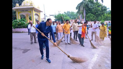Deputy chief minister Brajesh Pathak takes part in a cleanliness drive under the 'Sewa Pakhwada' campaign, organised on Prime Minister Narendra Modi's birthday, in Lucknow. (PTI)