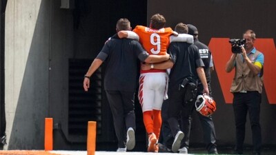 Cincinnati Bengals quarterback Joe Burrow (9) is assisted to the locker room with an injury. (IMAGN IMAGES via Reuters Connect)